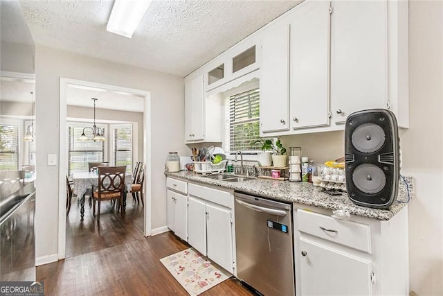 647 Sunshine Trce NW, Acworth, GA 30102 - kitchen with stainless steel dishwasher, dark wood-type flooring, white cabinetry, plenty of natural light, and a textured ceiling