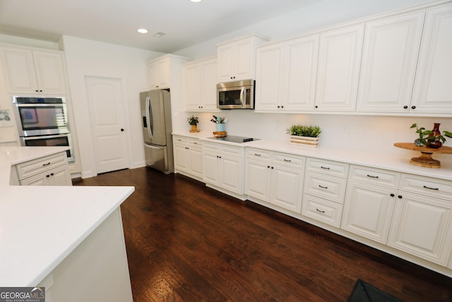 203 Drews Ridge Dr, Newnan, GA 30263 - kitchen featuring stainless steel appliances, light countertops, recessed lighting, white cabinets, and dark wood finished floors