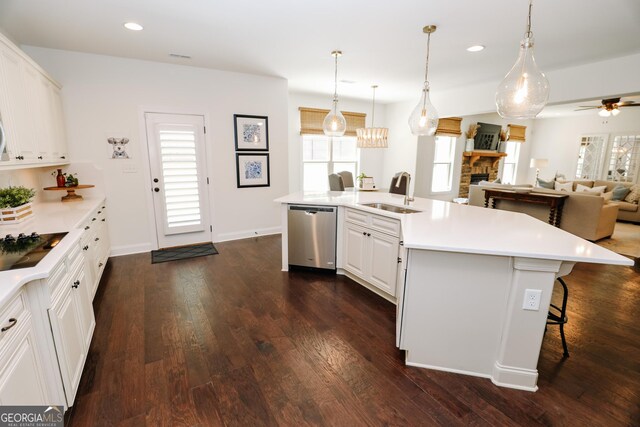 203 Drews Ridge Dr, Newnan, GA 30263 - kitchen featuring stainless steel dishwasher, healthy amount of natural light, a fireplace, dark wood-type flooring, and recessed lighting