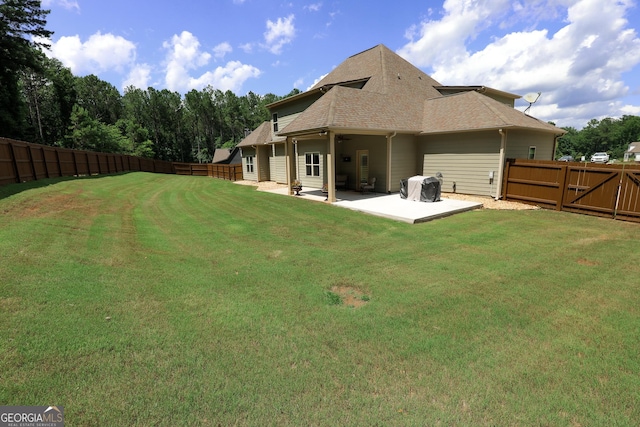 203 Drews Ridge Dr, Newnan, GA 30263 - rear view of property with a fenced backyard, a patio, and a shingled roof