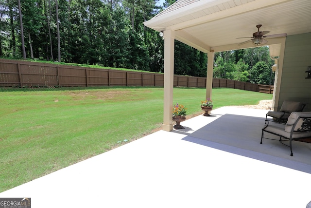 203 Drews Ridge Dr, Newnan, GA 30263 - fenced backyard featuring a ceiling fan and a patio area