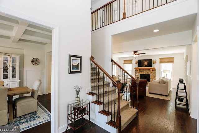 203 Drews Ridge Dr, Newnan, GA 30263 - stairway featuring a fireplace, ceiling fan, hardwood / wood-style flooring, coffered ceiling, and beam ceiling