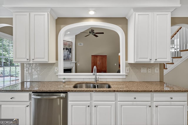 1065 Bookhout Dr, Cumming, GA 30041 - kitchen with dishwasher, arched walkways, a ceiling fan, white cabinets, and recessed lighting
