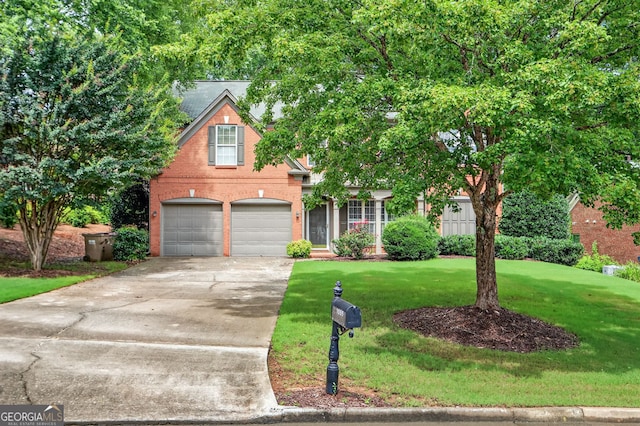 1065 Bookhout Dr, Cumming, GA 30041 - view of front of house with driveway, a front lawn, brick siding, and a garage