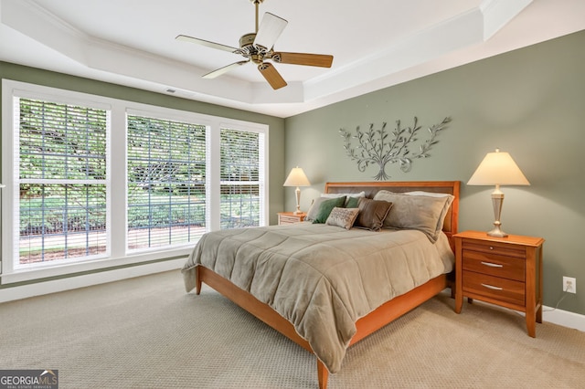 1065 Bookhout Dr, Cumming, GA 30041 - carpeted bedroom featuring a tray ceiling, ceiling fan, and crown molding
