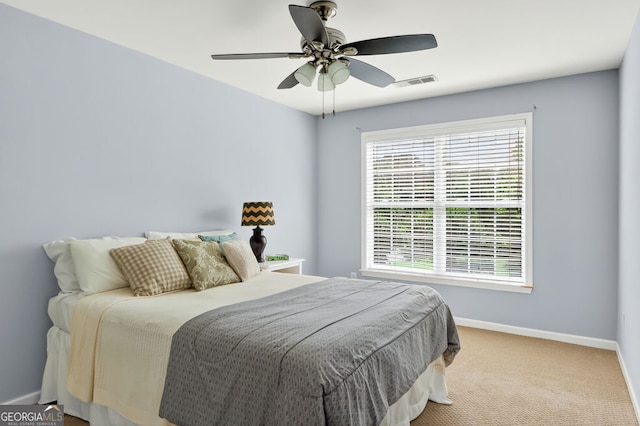 1065 Bookhout Dr, Cumming, GA 30041 - bedroom with multiple windows, carpet flooring, and ceiling fan
