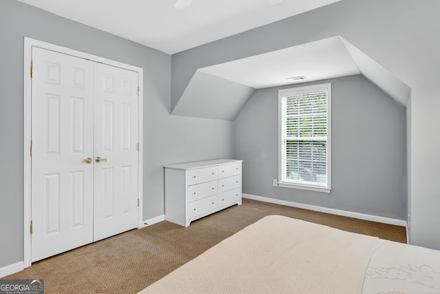 1065 Bookhout Dr, Cumming, GA 30041 - carpeted bedroom featuring vaulted ceiling and a closet