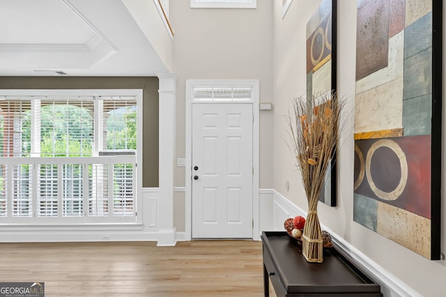 1065 Bookhout Dr, Cumming, GA 30041 - entrance foyer with wainscoting, light wood-type flooring, crown molding, and a decorative wall