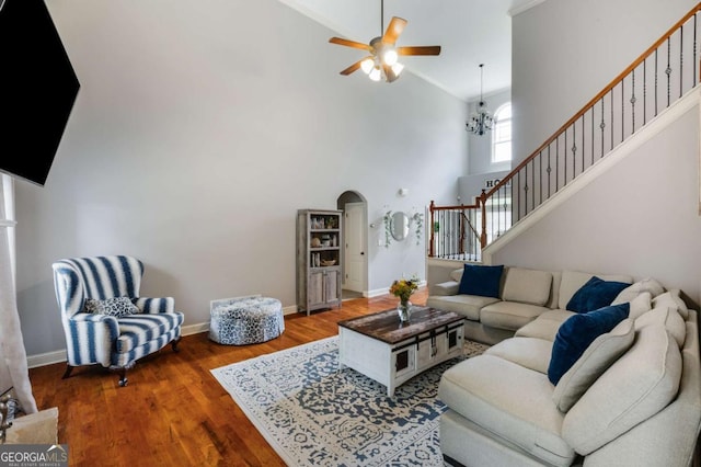 168 Gatlin Ridge Run, Dallas, GA 30157 - living room featuring high vaulted ceiling, stairway, a ceiling fan, arched walkways, and wood finished floors