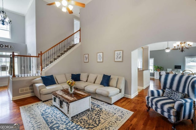 168 Gatlin Ridge Run, Dallas, GA 30157 - living area with a chandelier, a ceiling fan, a towering ceiling, healthy amount of natural light, and arched walkways