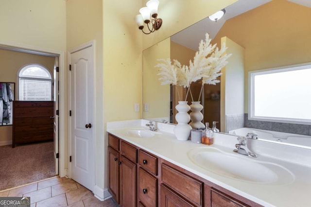 168 Gatlin Ridge Run, Dallas, GA 30157 - bathroom featuring healthy amount of natural light, double vanity, tile patterned floors, and a bathtub