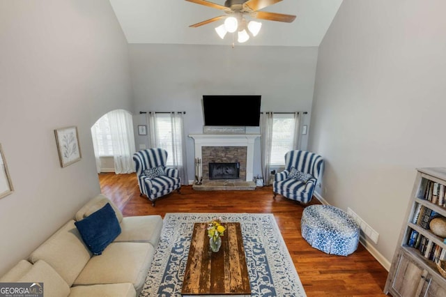 168 Gatlin Ridge Run, Dallas, GA 30157 - living room with healthy amount of natural light, ceiling fan, a stone fireplace, wood finished floors, and high vaulted ceiling
