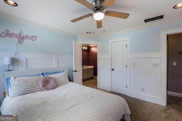 168 Gatlin Ridge Run, Dallas, GA 30157 - carpeted bedroom featuring a wainscoted wall, ornamental molding, connected bathroom, and a ceiling fan