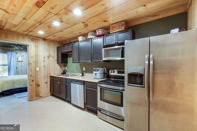 168 Gatlin Ridge Run, Dallas, GA 30157 - kitchen with stainless steel appliances, light countertops, finished concrete floors, wooden walls, and wooden ceiling