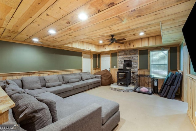 168 Gatlin Ridge Run, Dallas, GA 30157 - carpeted living area with a wood stove, wood ceiling, a wainscoted wall, a ceiling fan, and recessed lighting