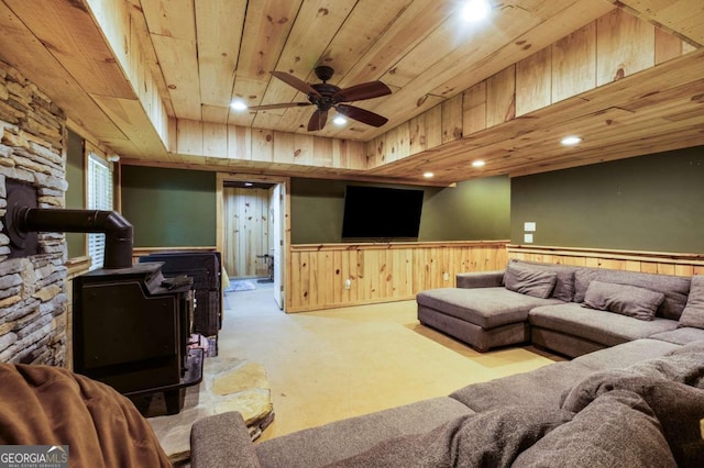 168 Gatlin Ridge Run, Dallas, GA 30157 - living room featuring wood ceiling, a wood stove, carpet floors, ceiling fan, and wainscoting