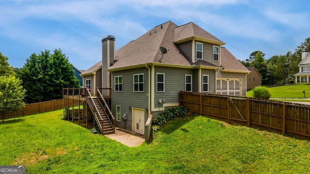 168 Gatlin Ridge Run, Dallas, GA 30157 - rear view of house with a deck, a fenced backyard, a chimney, stairway, and a garage