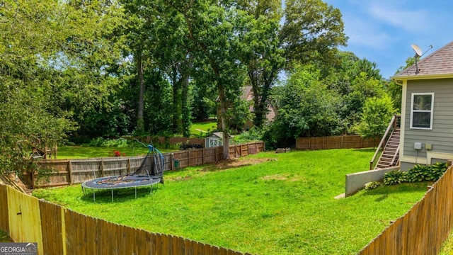 168 Gatlin Ridge Run, Dallas, GA 30157 - fenced backyard featuring a trampoline and stairway