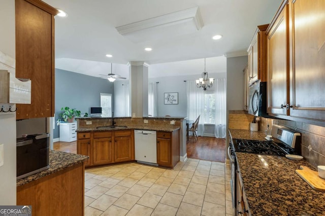 168 Gatlin Ridge Run, Dallas, GA 30157 - kitchen featuring stainless steel appliances, brown cabinets, backsplash, a ceiling fan, and dark stone counters