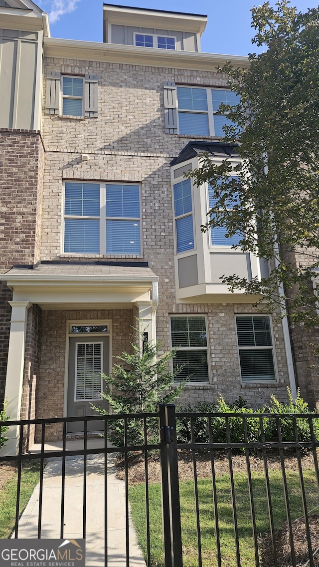 559 Fundao Ln # 21, Lawrenceville, GA 30046 - view of front of home featuring a fenced front yard and brick siding