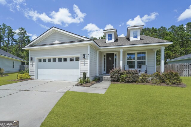 80 Rimmon Ct, Richmond Hill, GA 31324 - view of front of property featuring covered porch, driveway, and an attached garage