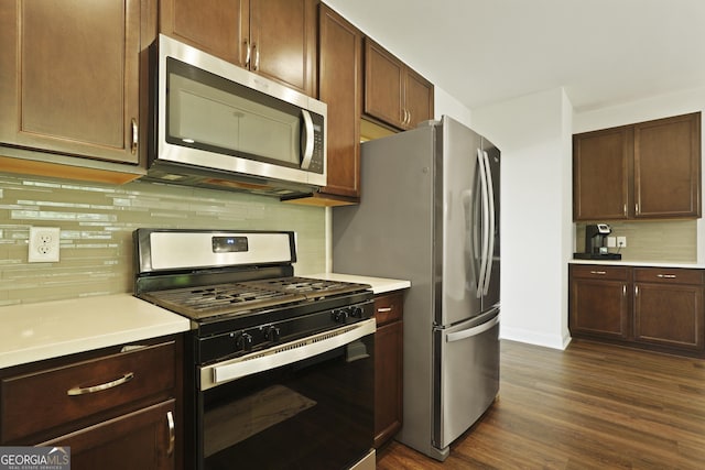 80 Rimmon Ct, Richmond Hill, GA 31324 - kitchen with stainless steel appliances, light countertops, dark wood-type flooring, decorative backsplash, and dark brown cabinetry
