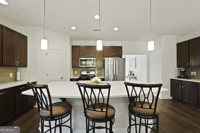 80 Rimmon Ct, Richmond Hill, GA 31324 - kitchen featuring appliances with stainless steel finishes, tasteful backsplash, dark wood finished floors, light countertops, and recessed lighting