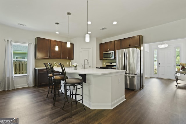 80 Rimmon Ct, Richmond Hill, GA 31324 - kitchen featuring appliances with stainless steel finishes, light countertops, dark wood-type flooring, and recessed lighting