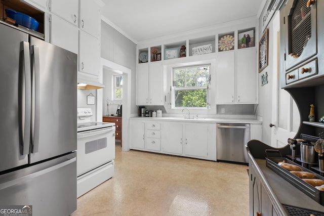 110 College Blvd, Statesboro, GA 30458 - kitchen featuring appliances with stainless steel finishes, ornamental molding, white cabinets, light countertops, and custom exhaust hood