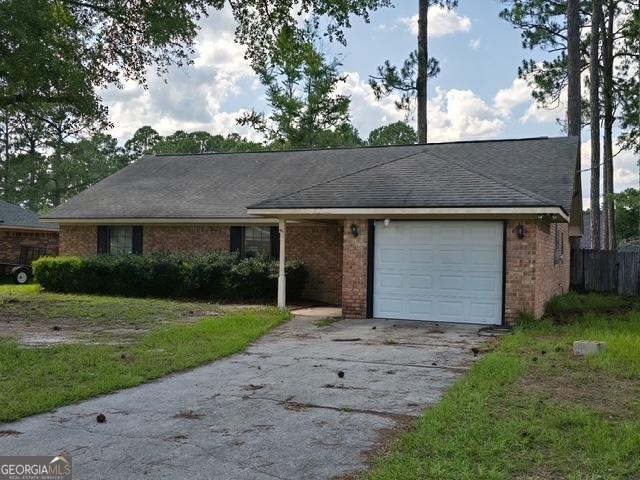 702 Friar Tuck Ln, Hinesville, GA 31313 - ranch-style house featuring an attached garage, asphalt driveway, brick siding, and a shingled roof
