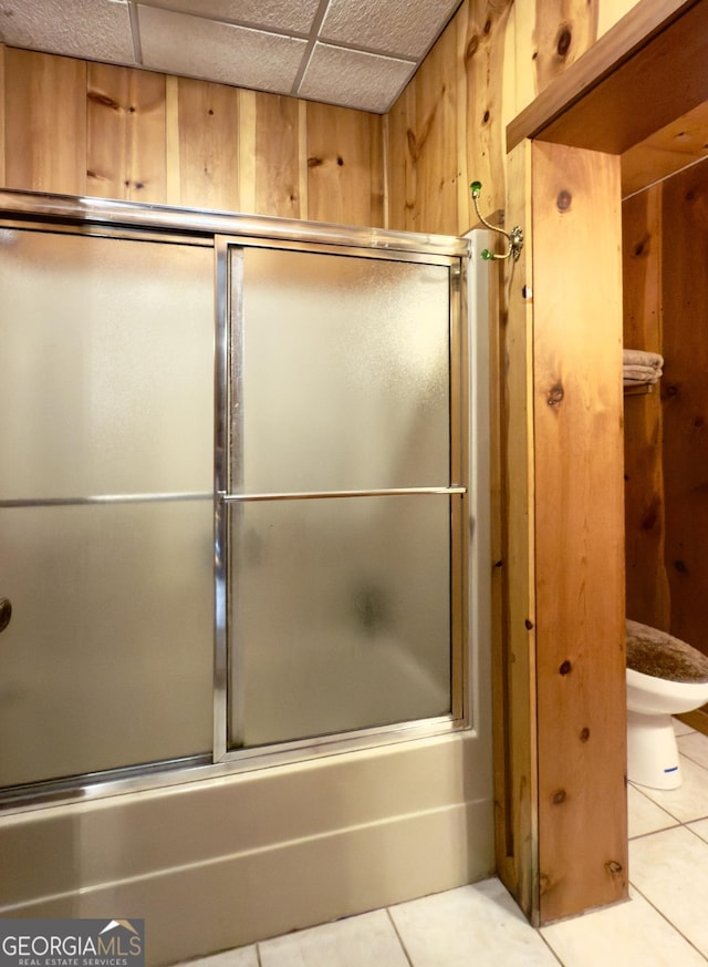 132 Wild Horse Cove Cir, Cleveland, GA 30528 - bathroom with tile patterned floors, shower / bath combination with glass door, and wooden walls