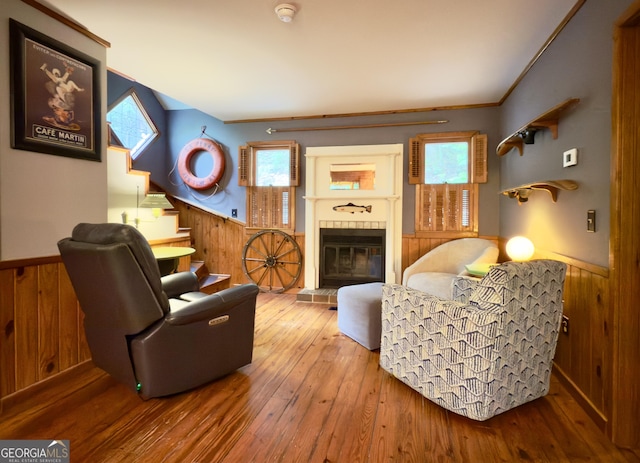 132 Wild Horse Cove Cir, Cleveland, GA 30528 - living room featuring wainscoting, wood walls, a tile fireplace, hardwood / wood-style flooring, and healthy amount of natural light