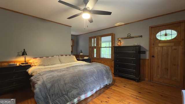 132 Wild Horse Cove Cir, Cleveland, GA 30528 - bedroom with ornamental molding, wainscoting, light wood finished floors, wooden walls, and a ceiling fan