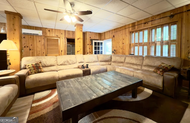 132 Wild Horse Cove Cir, Cleveland, GA 30528 - living room with a wall mounted air conditioner, wood walls, and ceiling fan