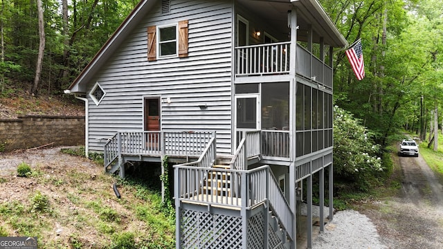 132 Wild Horse Cove Cir, Cleveland, GA 30528 - rear view of house featuring a balcony, stairs, and a sunroom