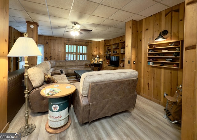 132 Wild Horse Cove Cir, Cleveland, GA 30528 - living room with wood walls, wood finished floors, a ceiling fan, and a drop ceiling