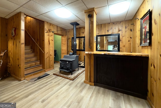 132 Wild Horse Cove Cir, Cleveland, GA 30528 - reception area featuring wood walls, a wood stove, stairway, and a drop ceiling
