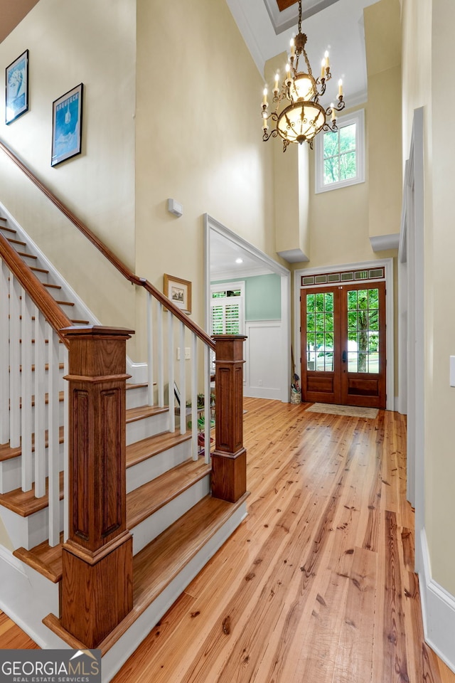 5130 Pratt St SW, Covington, GA 30014 - foyer entrance featuring a towering ceiling, french doors, stairway, a chandelier, and hardwood / wood-style flooring