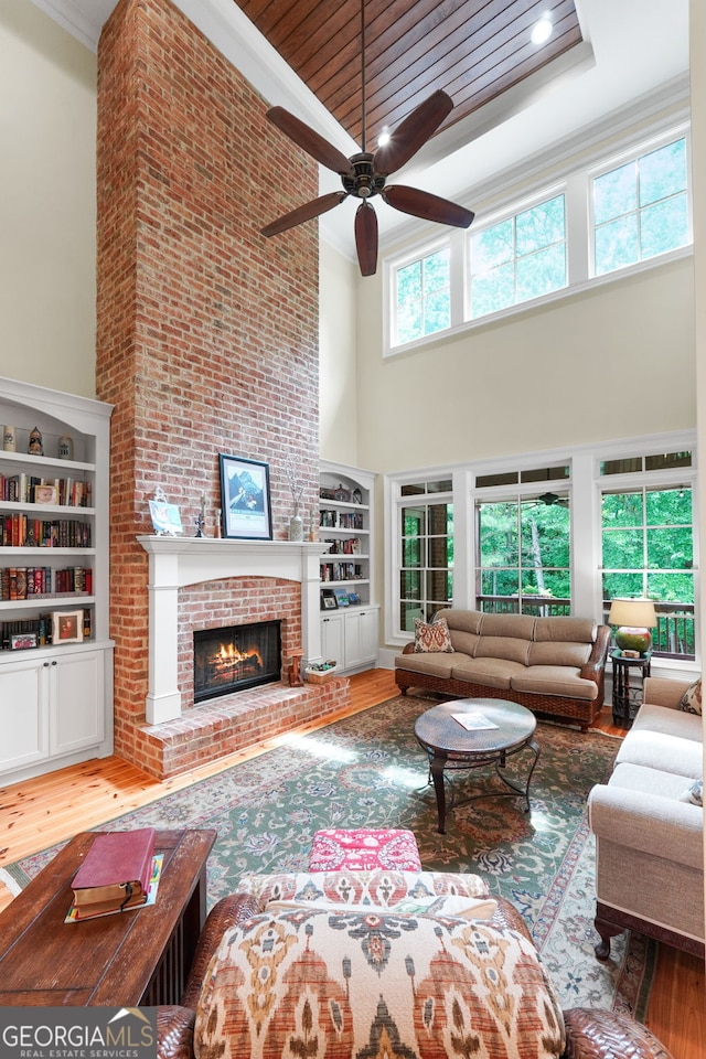 5130 Pratt St SW, Covington, GA 30014 - living area featuring a high ceiling, wood finished floors, ceiling fan, built in features, and ornamental molding