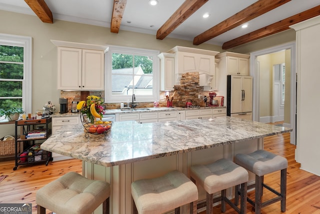 5130 Pratt St SW, Covington, GA 30014 - kitchen with paneled built in refrigerator, beam ceiling, tasteful backsplash, a kitchen breakfast bar, and recessed lighting