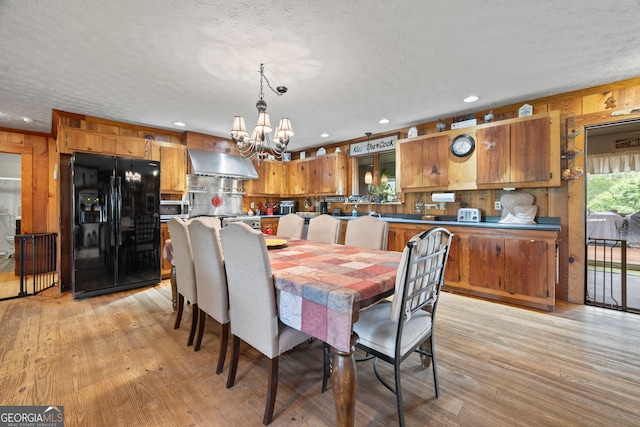 2296 Athens Rd, Royston, GA 30662 - dining room featuring a chandelier, light wood finished floors, recessed lighting, and wood walls