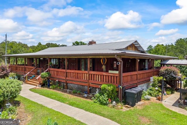 2296 Athens Rd, Royston, GA 30662 - view of front of property with a porch, a chimney, a front lawn, and a metal roof