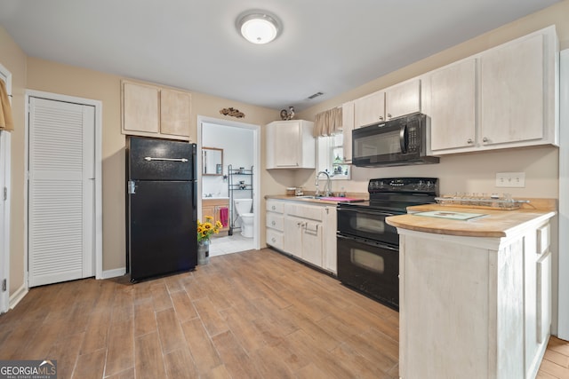 2296 Athens Rd, Royston, GA 30662 - kitchen with black appliances, light wood-style floors, and butcher block counters
