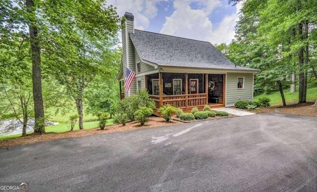 105 Evergreen Rd, Hiawassee, GA 30546 - view of front facade with a chimney, roof with shingles, and a porch