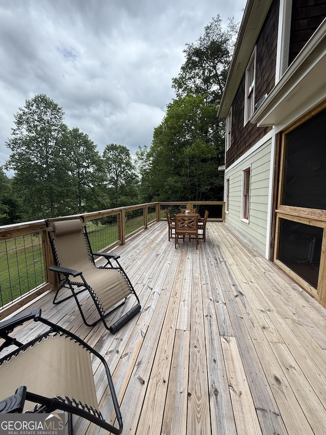 105 Evergreen Rd, Hiawassee, GA 30546 - deck with outdoor dining space and view of wooded area