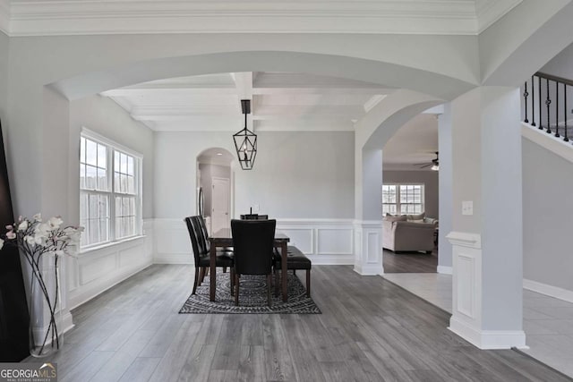358 Brookhaven Loop NE, Ludowici, GA 31316 - dining room featuring arched walkways, wood finished floors, stairs, a ceiling fan, and beamed ceiling