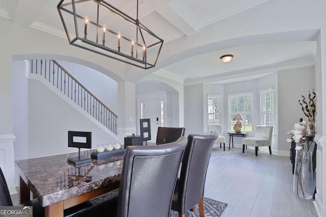 358 Brookhaven Loop NE, Ludowici, GA 31316 - dining space featuring arched walkways, stairs, light wood-style floors, and beamed ceiling