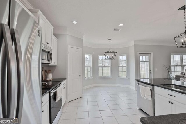 358 Brookhaven Loop NE, Ludowici, GA 31316 - kitchen with appliances with stainless steel finishes, a chandelier, white cabinetry, ornamental molding, and open floor plan