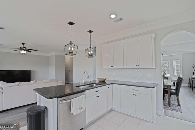 358 Brookhaven Loop NE, Ludowici, GA 31316 - kitchen with stainless steel dishwasher, white cabinetry, ornamental molding, ceiling fan, and a peninsula