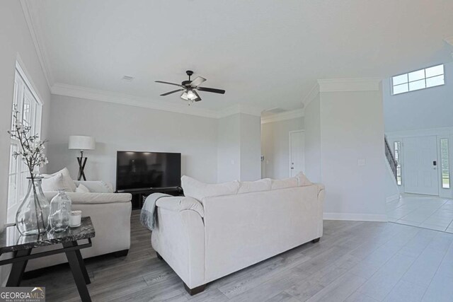 358 Brookhaven Loop NE, Ludowici, GA 31316 - living area featuring a ceiling fan, wood finished floors, stairway, and crown molding
